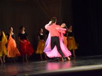 Taniec Towarzyski - tańcząca para na tle grupy